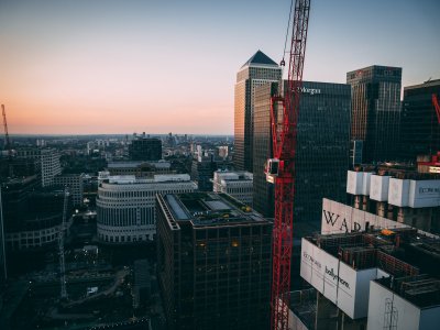 red tower crane between buildings