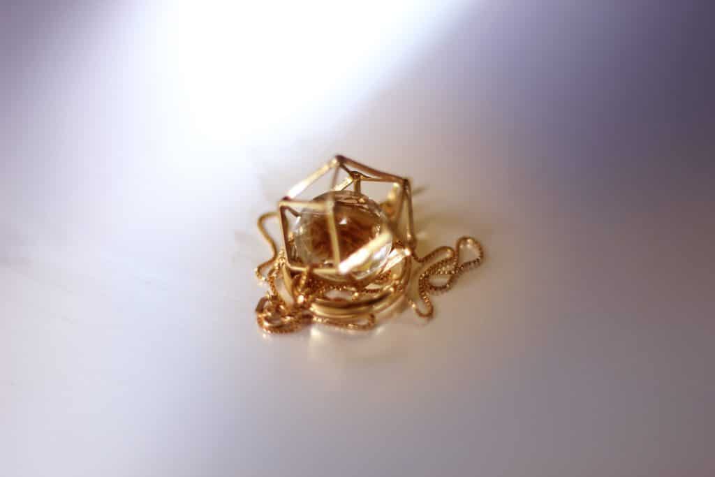 round gold-colored pendant
