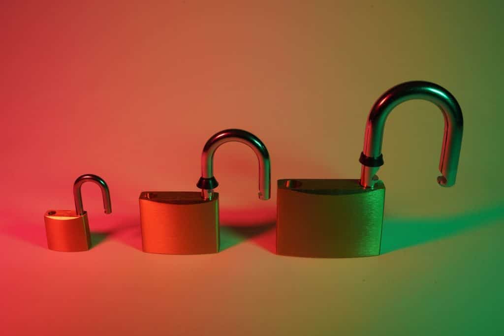 two green padlock on pink surface